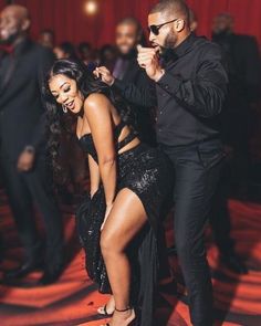 a man standing next to a woman on top of a dance floor