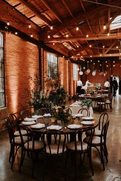 an indoor venue with tables and chairs set up for a wedding or other formal function