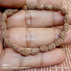 "Our Two Mukhi Bracelet is handcrafted with natural Two 2 Mukhi Rudraksha Beads. The most divine and beautiful form of unification is represented by the original 2 Mukhi Rudraksha. It symbolizes 'Ardhanareeshwara' which is the united form of Shiv and Shakti. The 2 Mukhi Rudraksha bead is the symbol of unification of mind and Soul symbolized by Shiva and Parvati or the Shivalinga. Wearing 2 Mukhi Rudraksha creates feelings of oneness and unity in any relationship between wife and husband, Guru Sh Traditional Handmade Beaded Bracelets For Meditation, Handmade Spiritual Bracelets For Rituals, Traditional Hand Wrapped Brown Bracelet, Handmade Bracelets For Puja And Festivals, Bohemian Bangle Bracelet For Puja, Spiritual Bangle Bracelets For Festivals, Traditional Handmade Rosary Bracelet With Round Beads, Adjustable Holistic Beaded Bracelets For Rituals, Traditional Handmade Rosary Bracelet