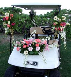 a golf cart decorated with flowers and greenery