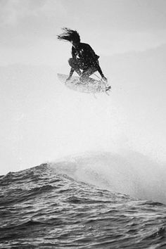 a person on a surfboard jumping in the air