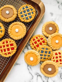 patriotic pies and tarts are on a cooling rack next to a tray of cookies