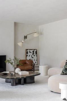 a living room filled with furniture and a flat screen tv mounted on the wall above it