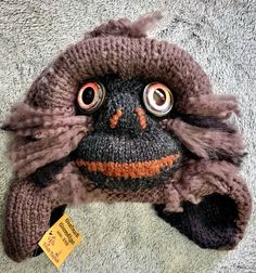 Each Bigfoot/Sasquatch hat is handmade--the combination of colors and yarn type, along with eye variations and expressions ensure that no two are exactly alike.  ITEM PICTURED IS WHAT YOU WILL RECEIVE (size in title).  Hats are warm and soft, with earflaps; each is individually named, using different world-wide terms for the Sasquatch. Sizes are suitable for adults and older children (smaller sizes can be requested).  As they are knit and do stretch, the average size fits most.  Hats come prewashed so there is no fear of shrinking.  Nearly all yarn is acrylic, but some have a small percentage of wool or other natural fiber. I have been interested in Sasquatch (the name I prefer) since childhood.  I believe that there are undiscovered species in this world, small and large, that have manage Handmade Fun Winter Hats, Handmade Brown Beanie One Size, Fun Handmade Winter Hats, Handmade Hats For Outdoor, One Size Fits Most, Handmade Brown Hat, One Size Fits Most, Handmade Outdoor Hat One Size Fits Most, Handmade Outdoor Hat (one Size Fits Most), Quirky Handmade Winter Hats, Handmade Outdoor Hat