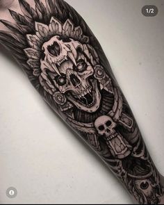 a man's arm with a skull and wings tattoo design on the left forearm