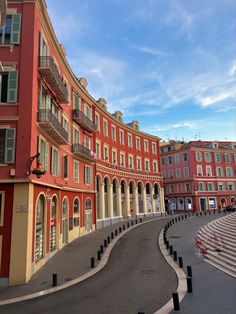 an empty street lined with red and yellow buildings