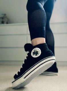 Black Crochet Sneakers Slippers / High Tops Sneaker Slippers / Sofa socks.  High top sneaker style crocheted slippers with flowers embroidered button detail.  Soft and stylish crochet house shoes.  Lightweight and comfortable.  Made of soft acrylic yarn. All star converse inspired.  Also available in RED: https://www.etsy.com/uk/listing/1130565531/ And BLUE: https://www.etsy.com/uk/listing/1363070550/ Sizes: S - 3/4 M - 5/6 L - 7/8 The stretchy nature of yarn allow for them to fit many sizes)  C Crochet House Shoes, Converse Slippers, Crochet Sneakers, Crochet House, Crocheted Slippers, Sneakers Slippers, All Star Converse, High Tops Sneakers, Flowers Embroidered