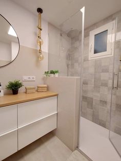 a bathroom with a shower, sink and mirror