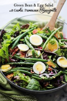 a salad with green beans, hard boiled eggs and bacon