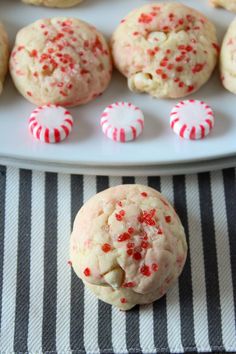 peppermint white chocolate chip cookies are on a plate with candy canes next to them