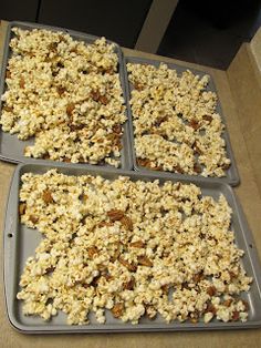 four trays filled with popcorn sitting on top of a counter