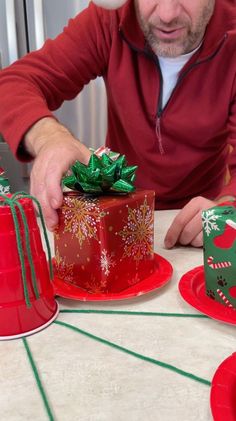 a man is decorating a christmas cake