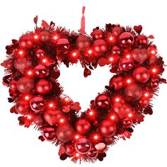 a heart - shaped wreath with red ornaments and lights on it is displayed against a white background