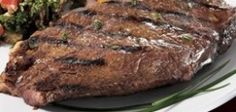 a steak and some vegetables on a white plate