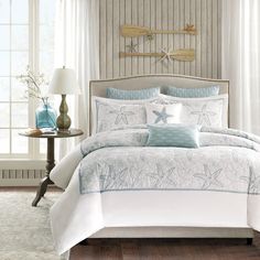 a bed with blue and white comforters in a bedroom