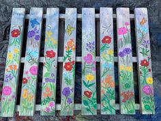 painted wooden slats with flowers and butterflies on them