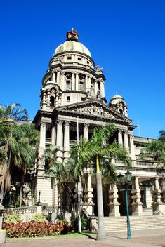 an old building with palm trees in front of it