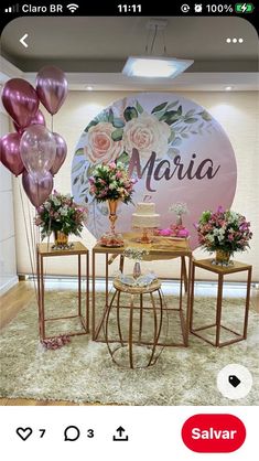 a table with some balloons and flowers on it