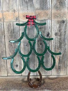 a christmas tree made out of horseshoes on top of a table