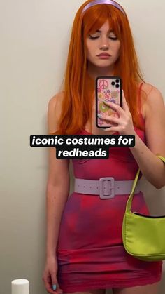 a woman with red hair is taking a selfie in front of a mirror wearing a pink dress