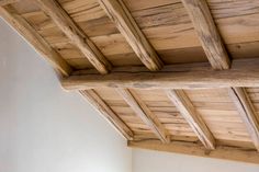 the ceiling is made of wood and has exposed rafters on it's sides