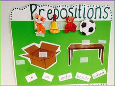 a green bulletin board with cut outs and pictures on it that say prepositions