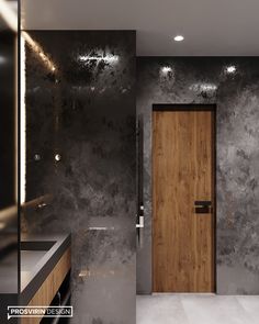 a bathroom with marble walls and wooden door