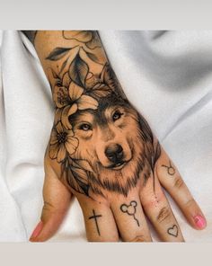 a woman's hand with a tattoo on it and a wolf in the middle