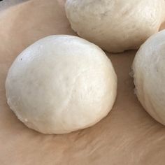 three uncooked doughnuts sitting on top of a table next to each other