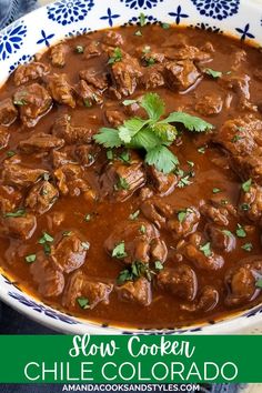 slow cooker chili chicken in a blue and white bowl with cilantro garnish