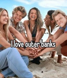 four people holding hands together with the words i love outer banks in front of them