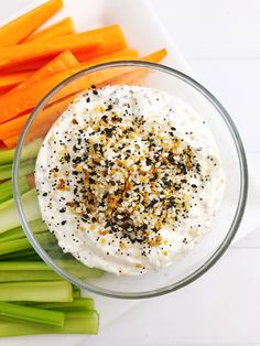 carrots, celery and other vegetables on a plate with cream cheese in the center