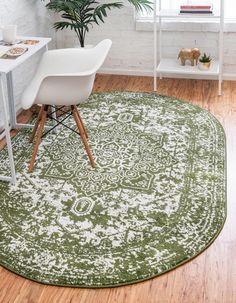 a green and white area rug in an office with a chair, desk and potted plant