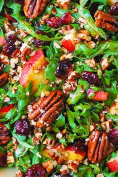 a salad with apples, cranberries and pecans