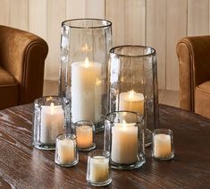 a group of candles sitting on top of a wooden table