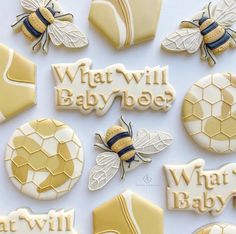 some cookies that are decorated to look like honeybees and beehives with the words what will baby bee written on them