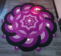 a purple and black circular design on the floor with candles lit up in the background