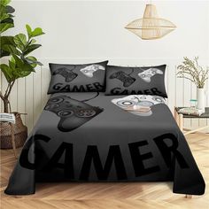 a bed covered in black and white gaming themed sheets