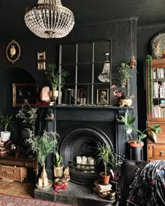 a living room filled with furniture and a fire place under a chandelier above a fireplace