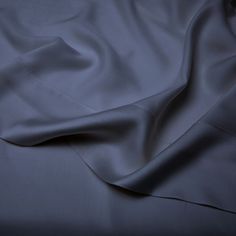 a close up view of a bed sheet with the sheets pulled back and folded down