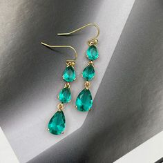 ❤️Deliver gifts on time with our recommended ship-by dates.❤️ - 16 DEC USPS first class mail - 18 DEC USPS Priority mail - 20 DEC USPS Priority mail express Earrings made from faceted turquoise green crystals and gold framed teardrop crystals same color.  They are perfect for evening and also look great as a statement accessory on a casual outfit! They would make a fabulous gift for Christmas, birthday or Valentines Day! Matching charm necklace is available for purchase (NOT included with earrings). Measurements: The total length from the top of the hook to bottom - 1.85 inches (47 mm) approximately. Teardrop crystals 14 mm x 8 mm Connector crystals: 6 mm x 8 mm These earrings would be a PERFECT GIFT for you and your family and friends! Our jewelry comes beautifully packaged in a gift box! May Birthstone Crystal Dangle Earrings For Party, Turquoise Drop Jewelry For Party, Green Drop Crystal Earrings For Party, Teardrop Green Crystal Earrings, Green Dangle Teardrop Earrings For Party, Elegant Turquoise Teardrop Earrings For Party, Green Pear-shaped Earrings For Party, Bridesmaid Green, Drop Earrings Wedding