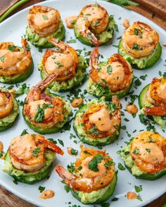 some food that is on top of cucumbers and has shrimp in the middle