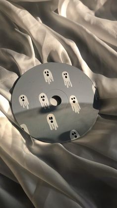 a metal object with white ghost faces on it