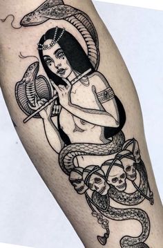 a woman holding a fan and snake tattoo on her arm with other items around her