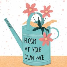 a blue watering can with flowers on it and the words bloom at your own pace