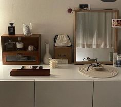 a bathroom vanity with a mirror, sink and other items on top of the counter