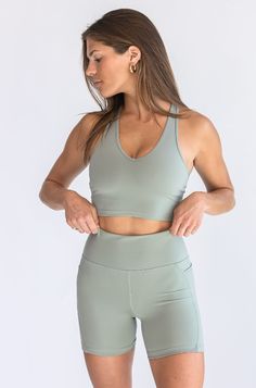 Introducing our V-Neck Bra Top, a versatile addition to our Coast to Coast Collection, designed to effortlessly blend fashion and sustainability. Crafted from 83% recycled polyester, this bra top redefines comfort and style in activewear. The elegant V-neck design adds a touch of sophistication to your activewear ensemble, making it perfect for both workout sessions and casual outings. Dusty Sage, Coast To Coast, Workout Session, Bra Top, White Tops, Bra Tops, Neck Designs, Sustainability, Active Wear