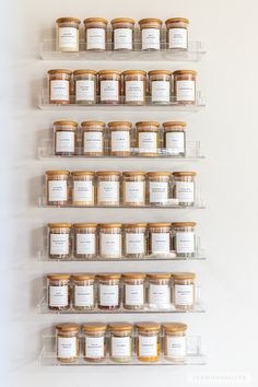 several shelves with jars and labels on them