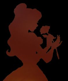 the silhouette of a woman holding a flower