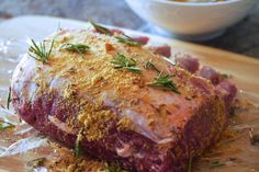 a large piece of meat sitting on top of a wooden cutting board